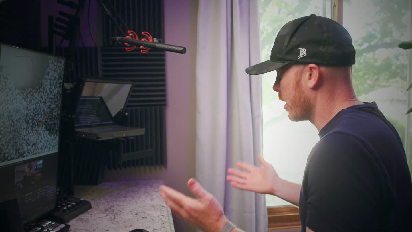 Tyler recording in his studio with the ScriptFox prompter beside the camera